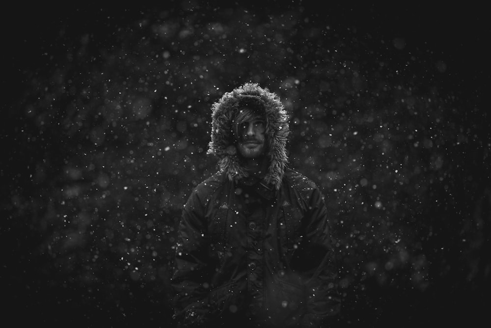 man wearing parka jacket in snow