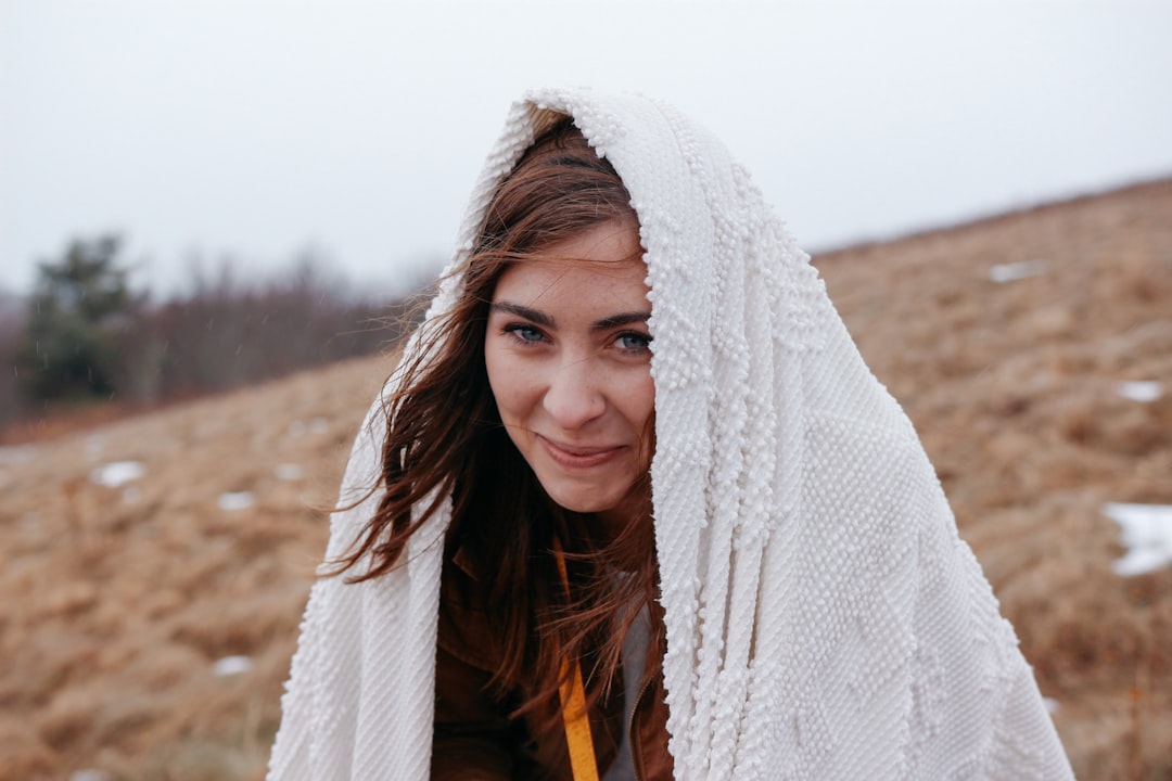 smiling woman wrapped with white headscarf,