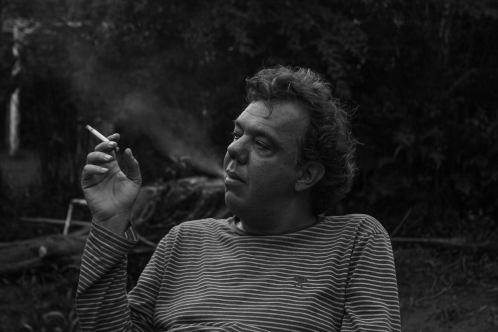 grayscale photography of man white smoking