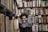 woman holding book covering half face