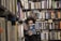 woman holding book covering half face