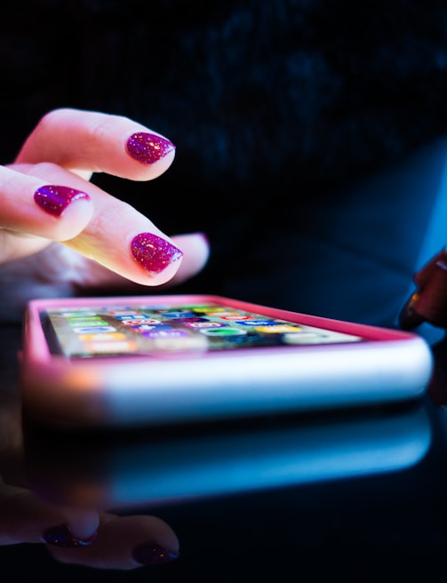 person using black smartphone with gray and pink case