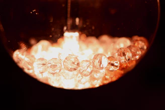 A close-up of a natural crystal ball glowing softly in dim light.