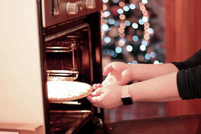 Chef placing pizza into the oven, capturing the moment of creation.