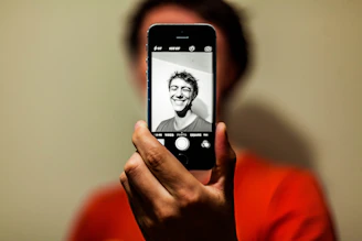 person holding space gray iPhone 5s taking picture
