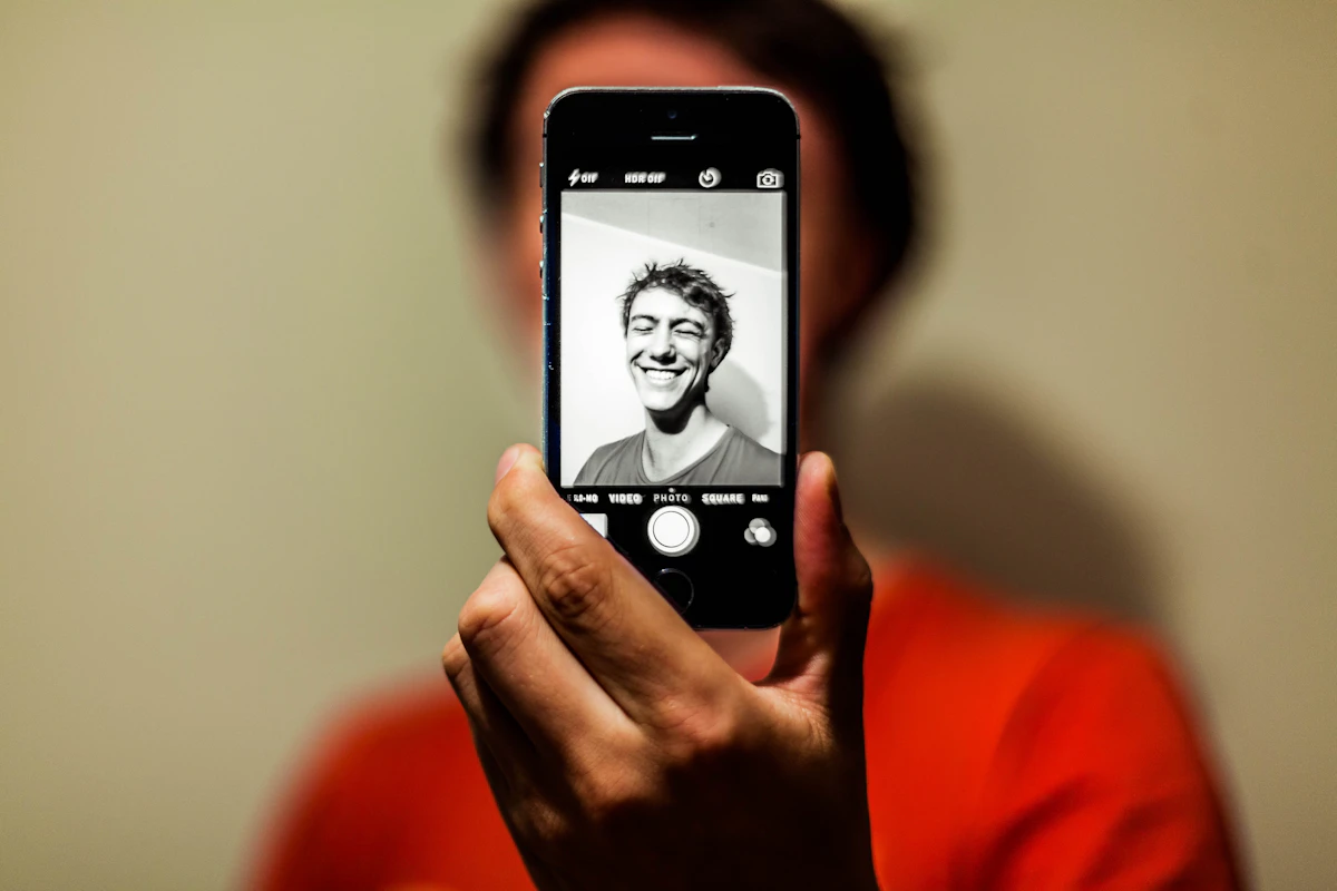 A person holding a phone taking a picture
