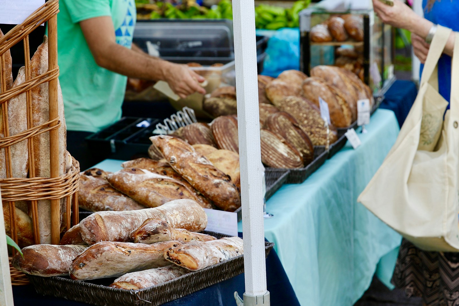 Someone selling freshly baked bread at a farmer's market