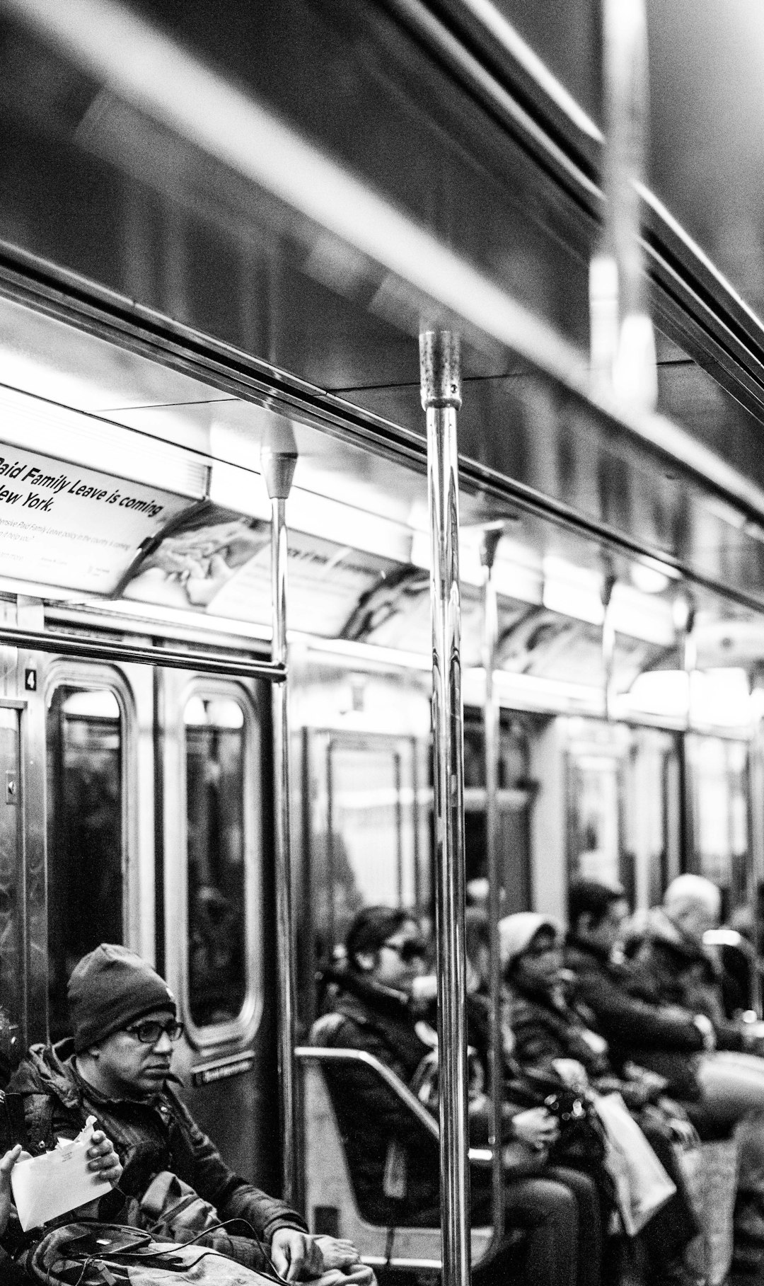 grayscale photo of people inside train