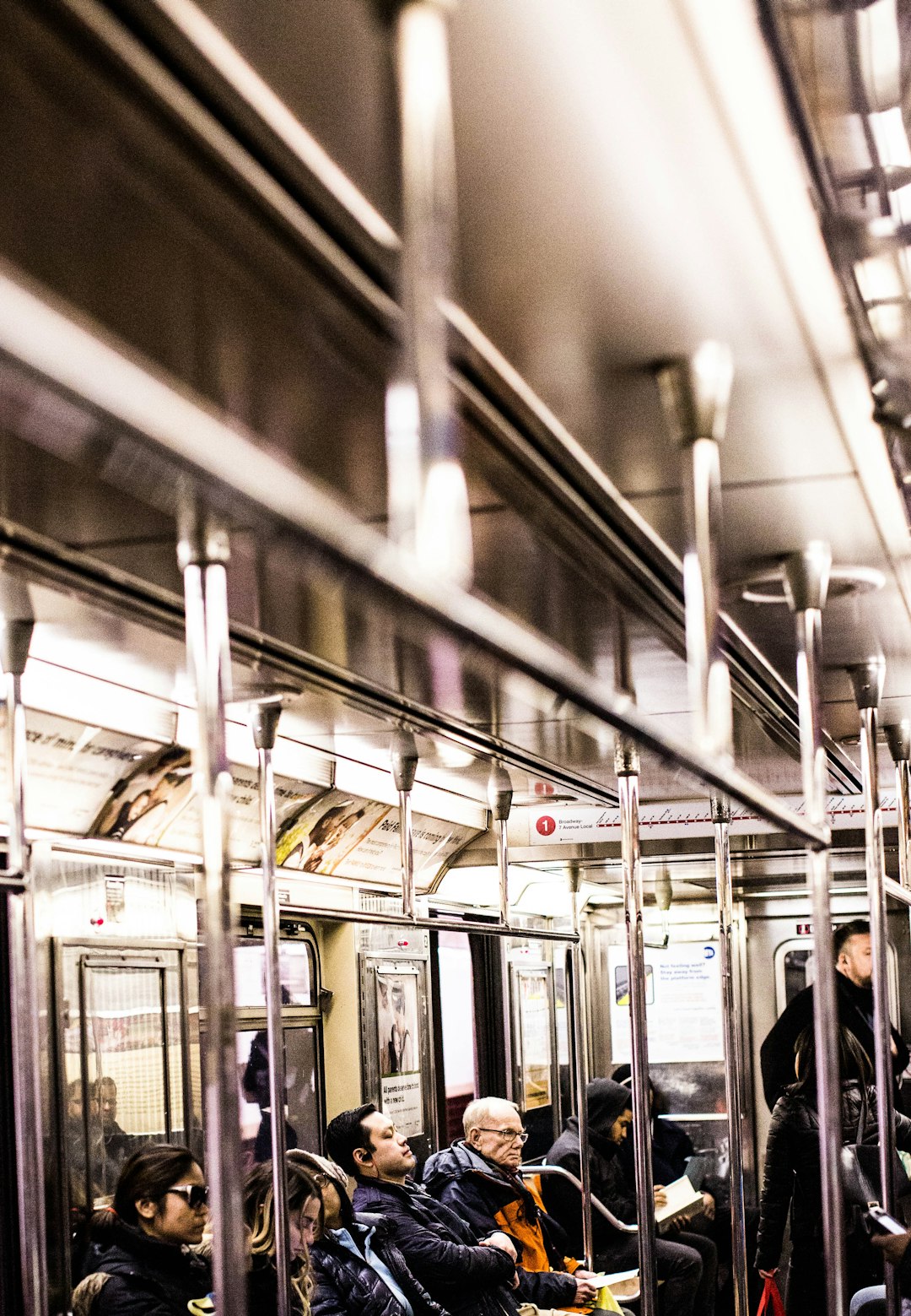 people sitting and standing inside train