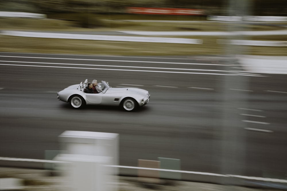 white convertible coupe on asphalt road during daytime