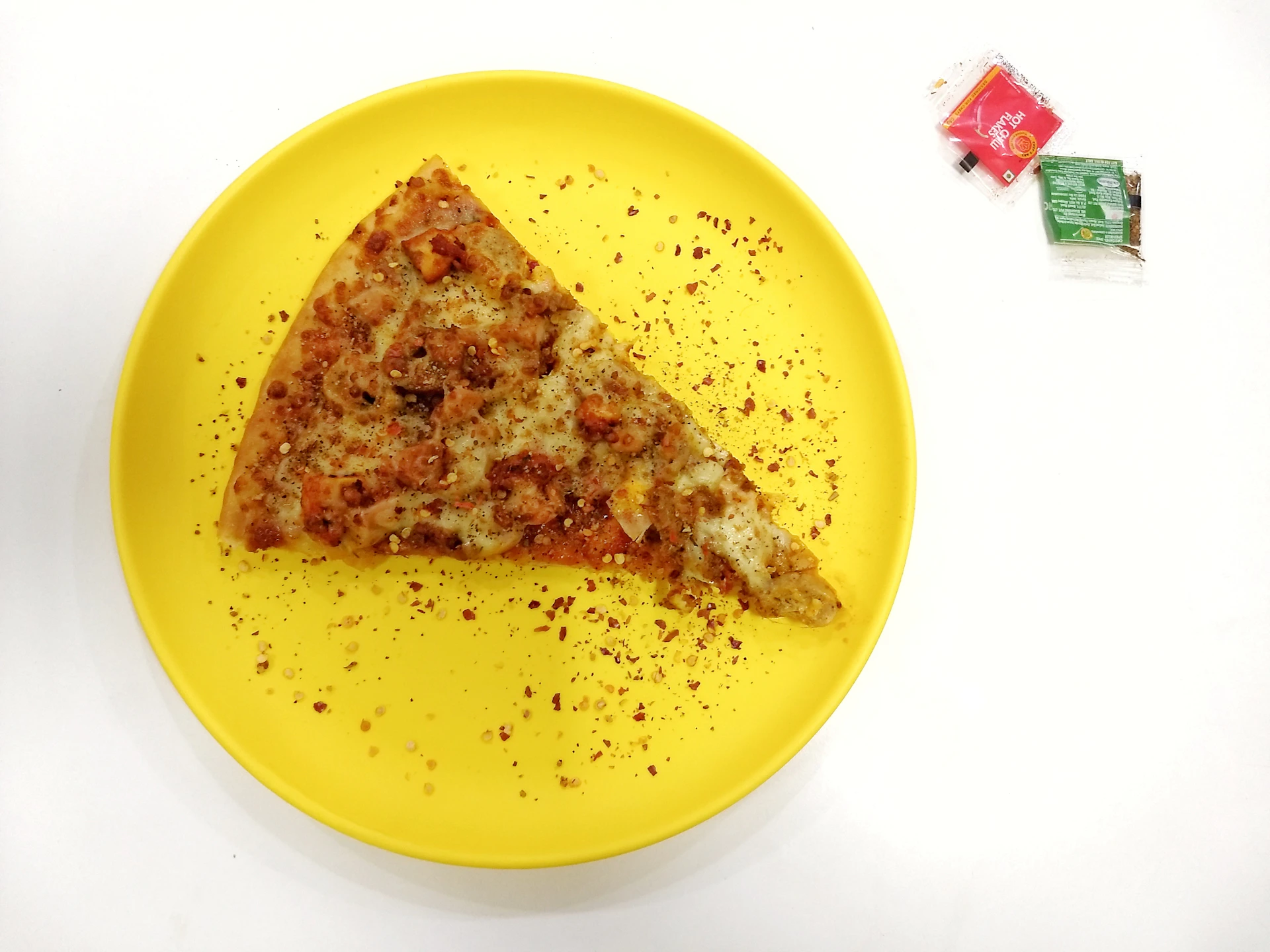 A beautifully plated slice of Unique Jack Pizza with a side of tangy chutney, set against a warm, inviting restaurant backdrop.