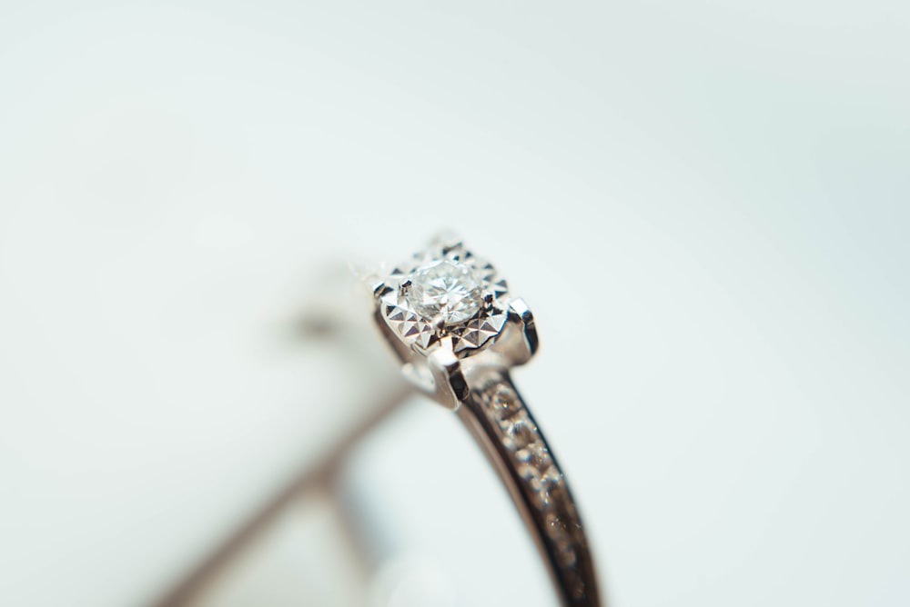 silver-colored clear gemstone ring