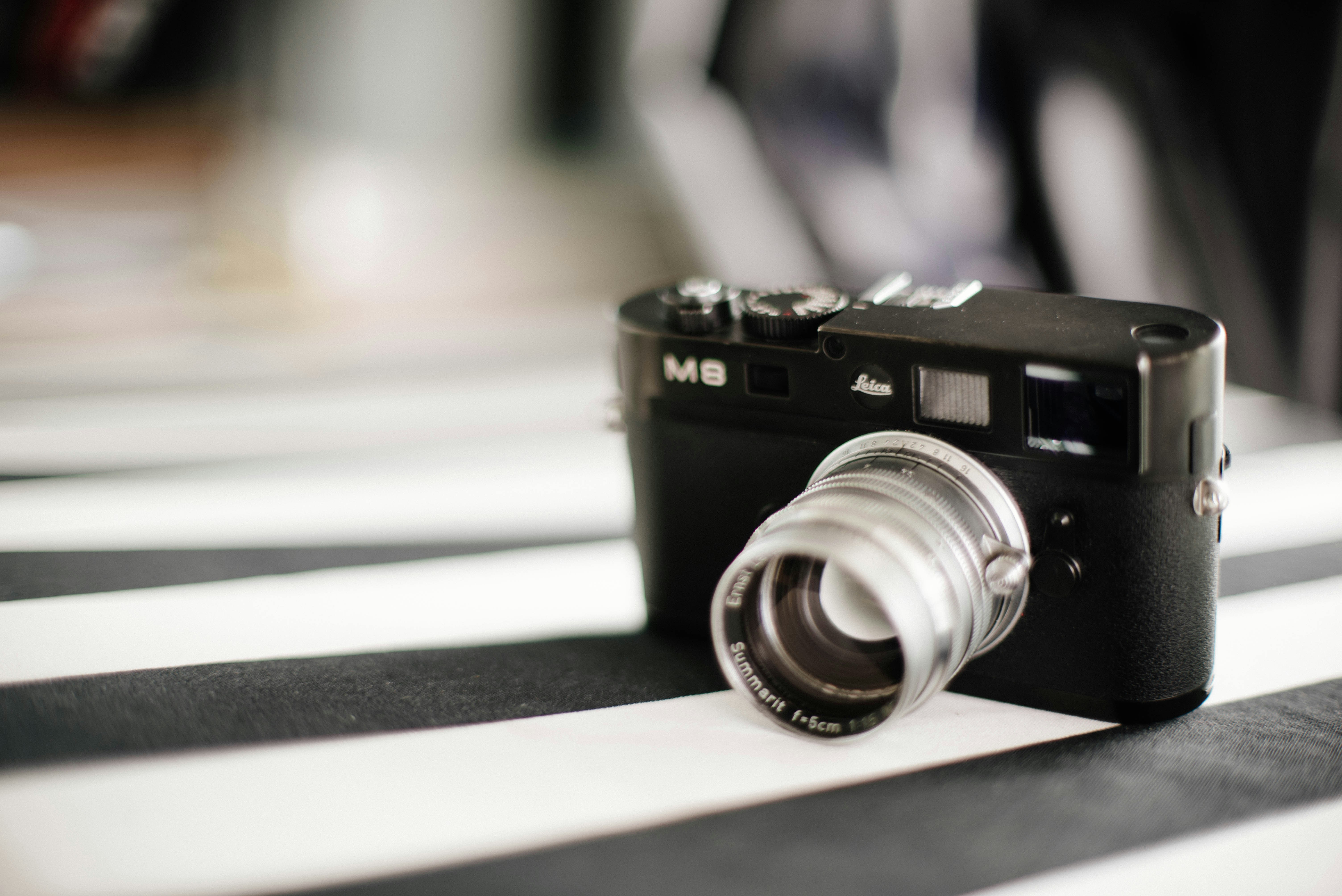 camera on white and black striped fabric cover