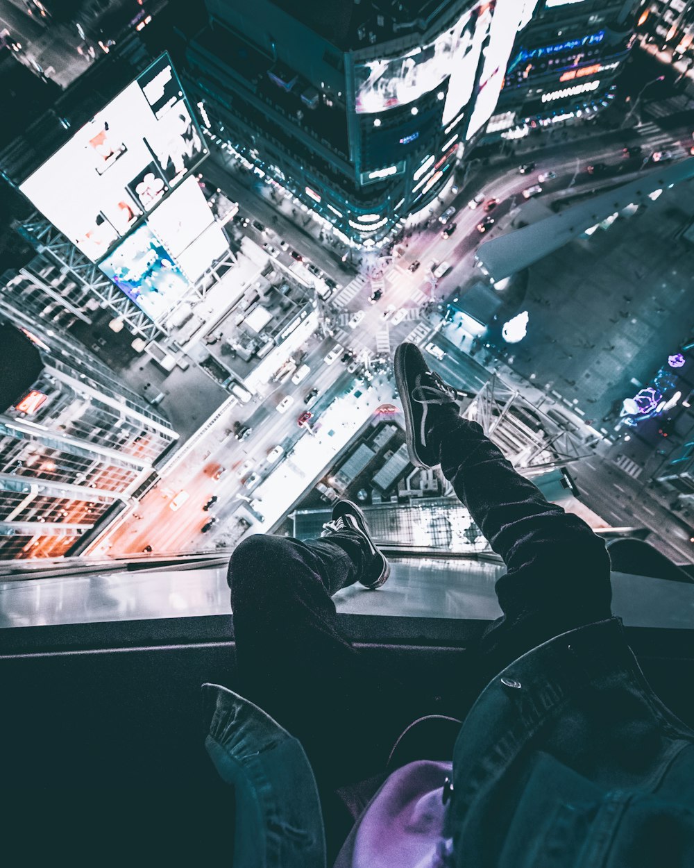 person sitting on top of the building during nighttime