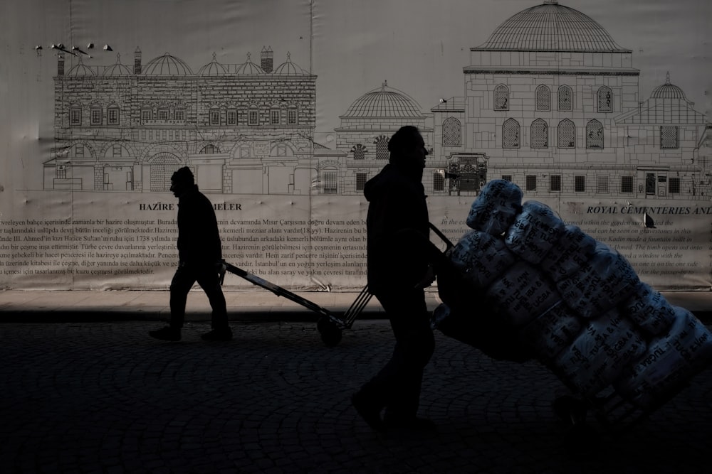 silhouette of man and woman walking on street