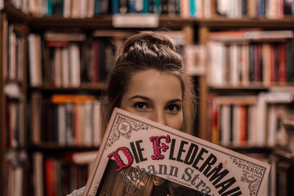 woman covered her face with book