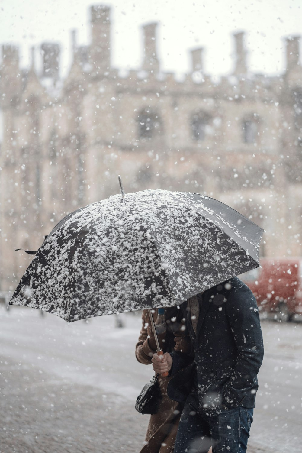 person holding black umbrella