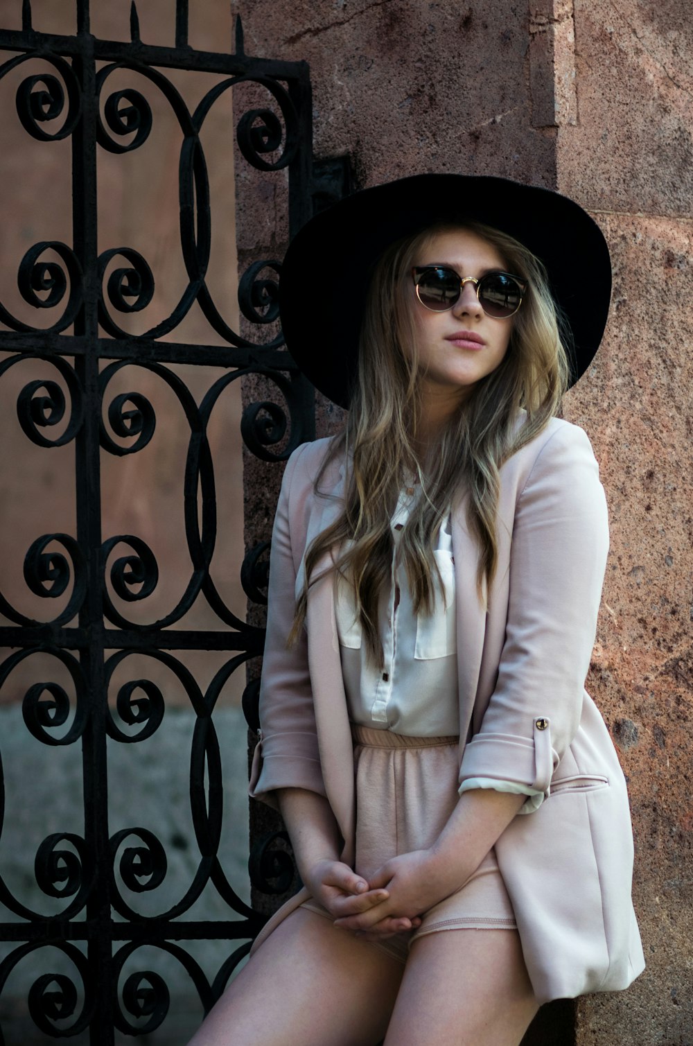 woman wearing pink dress against the metal wall