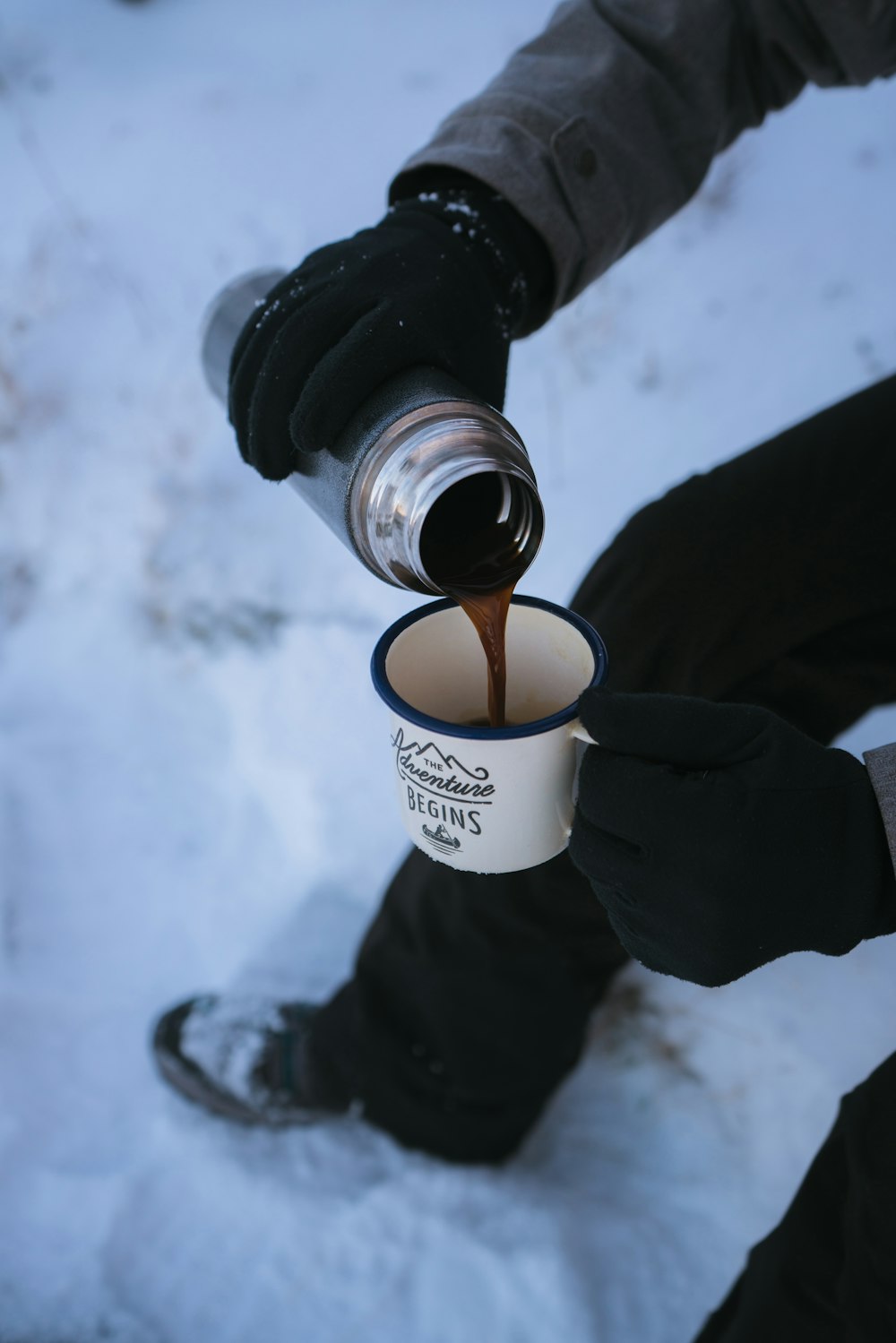 person pouring coffee in mug