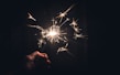 Close-up of sparklers glowing in hand