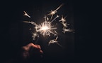 Close-up of sparklers glowing in hand
