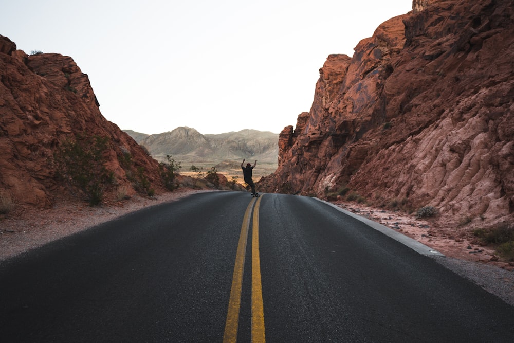 man skateboarding in the road