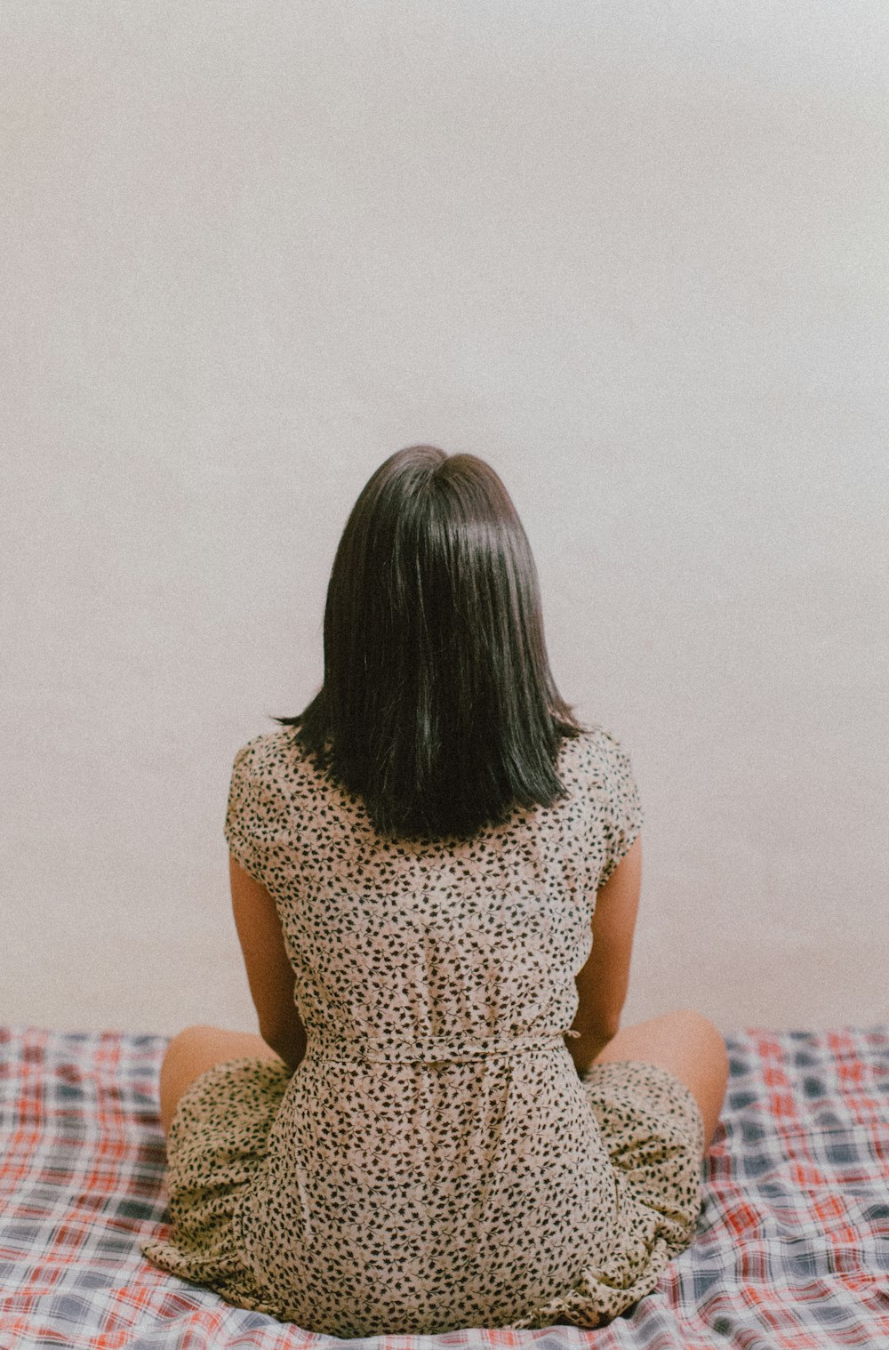 woman sitting on bed