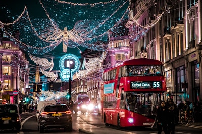 photo of bus passing on city with lights