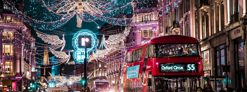 photo of bus passing on city with lights