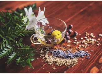 clear tea cup on brown surface