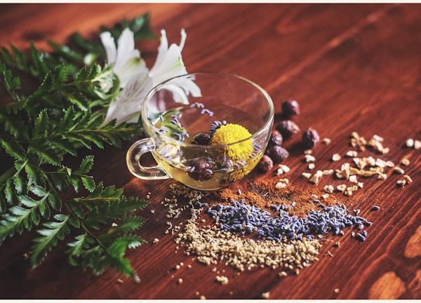 clear tea cup on brown surface