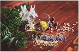 clear tea cup on brown surface