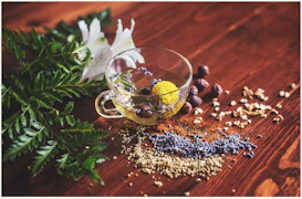 clear tea cup on brown surface