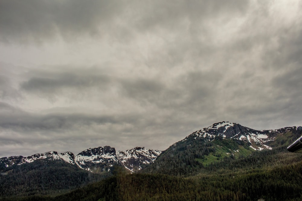 snow-covered mountains during cloudy day