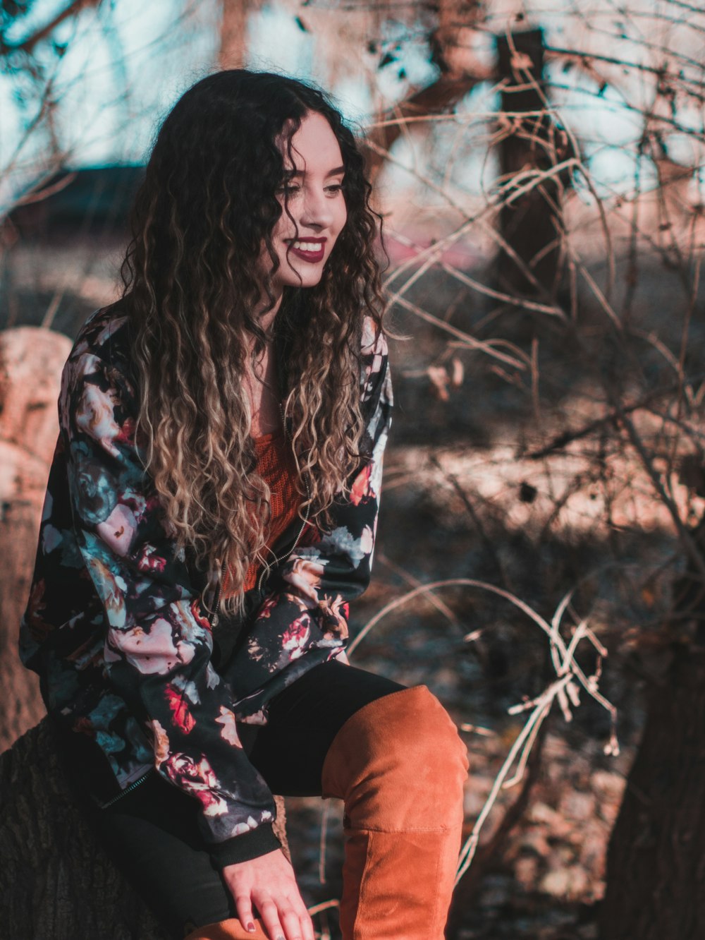 photo of sitting woman surrounded with twigs