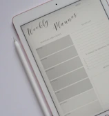flat lay photography of turned-on silver iPad beside Apple Pencil