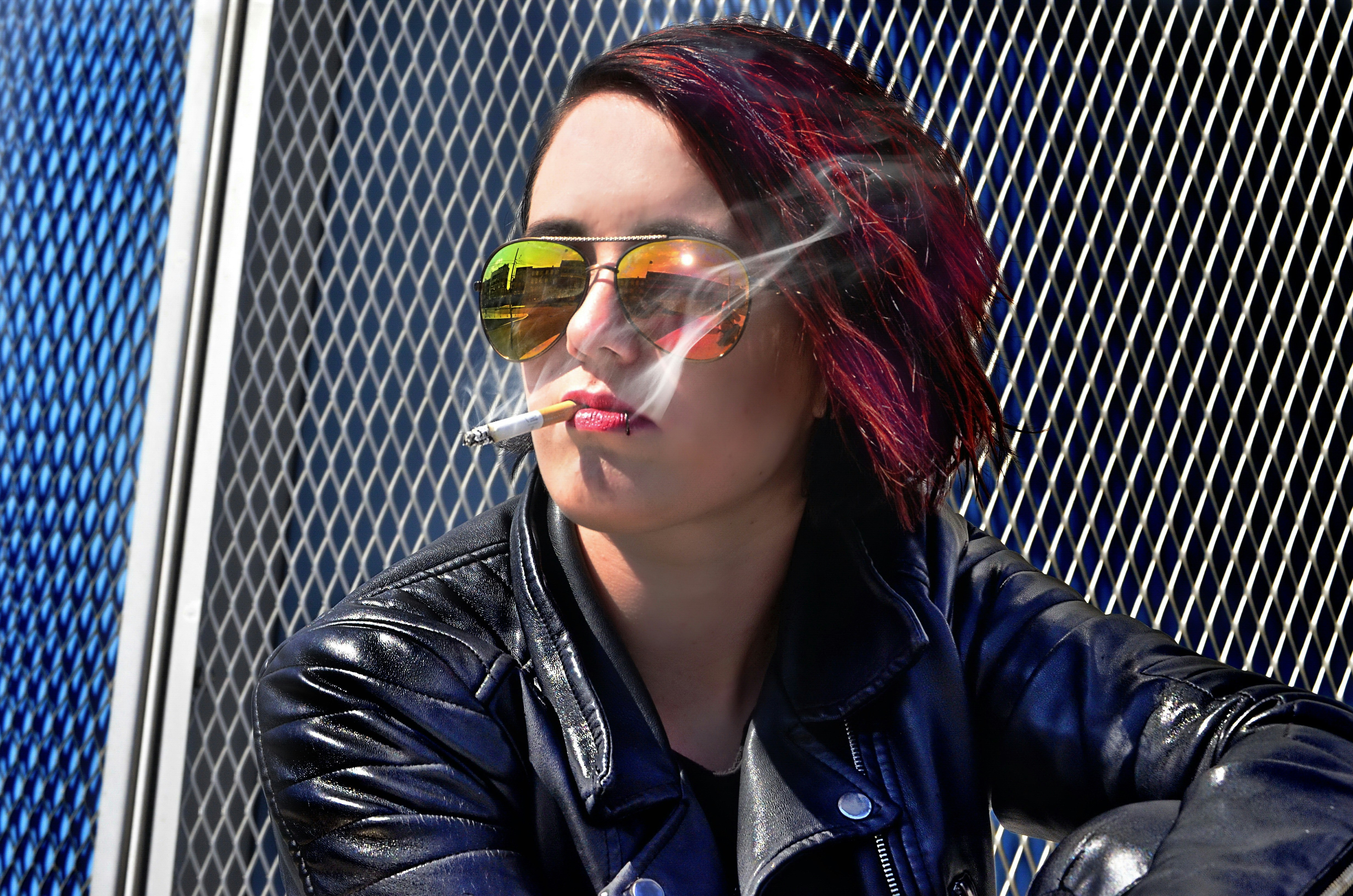woman sitting while smoking