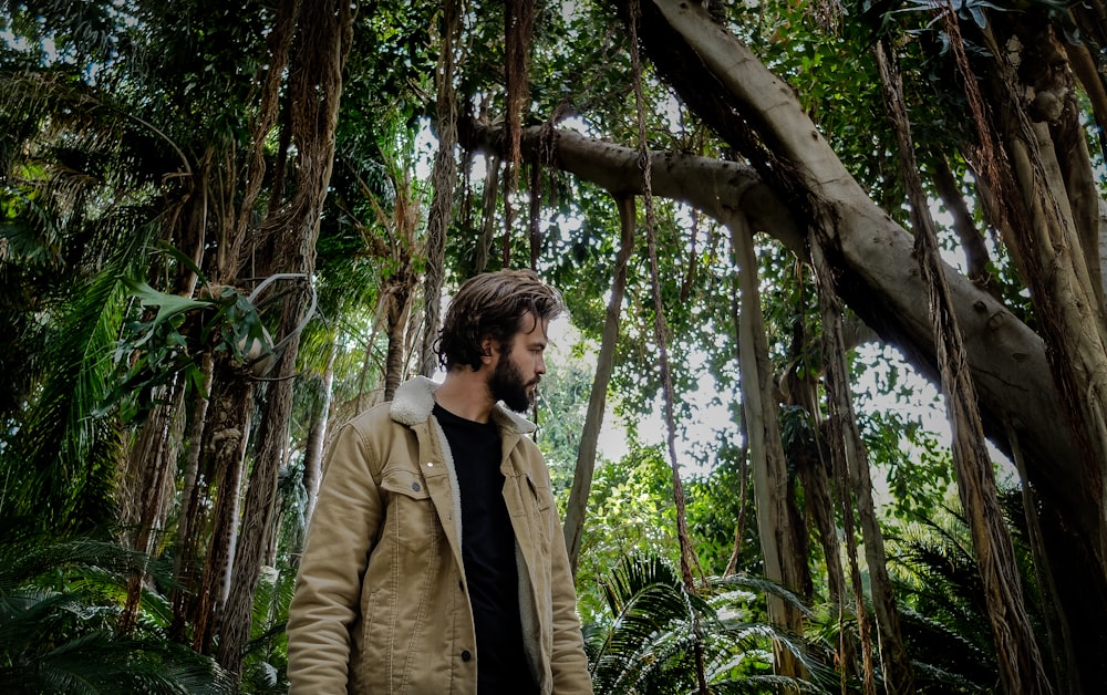 man walking under tree