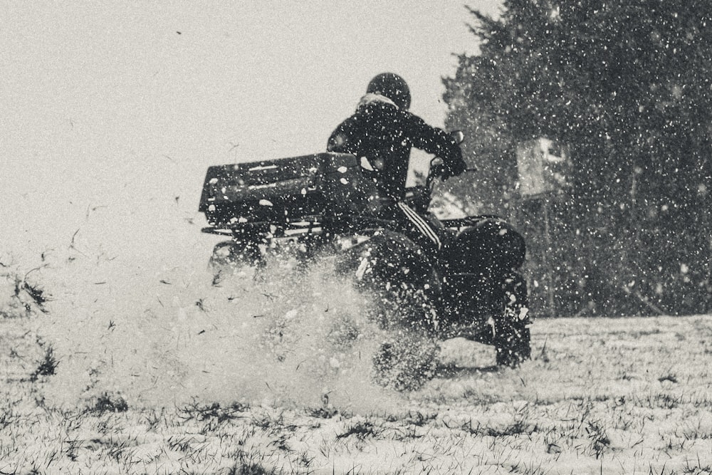 a person riding a four - wheeler in the snow