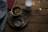 A cozy home space with herbal teas and wellness books on a wooden table.