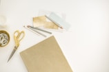 A creative workspace filled with gold and silver materials.