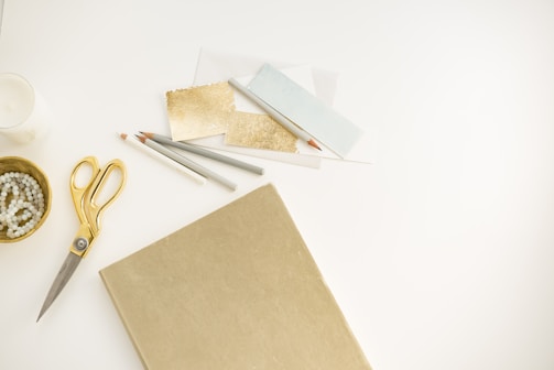 A creative workspace filled with gold and silver materials.