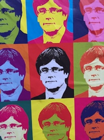 The image consists of a grid of nine portraits of the same person, each rendered in a style reminiscent of pop art. The portraits feature vibrant, contrasting colors with the subject positioned in the center of each section. The overall composition is colorful and visually striking, showcasing a variety of hues in each individual square.