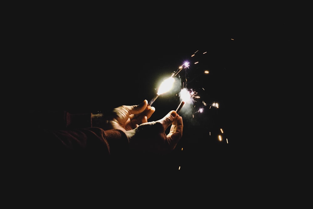 person holding two sparklers