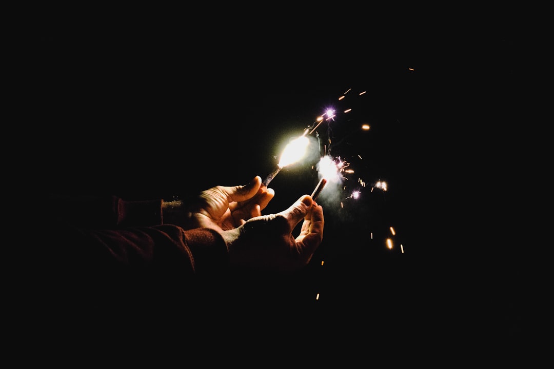 person holding two sparklers