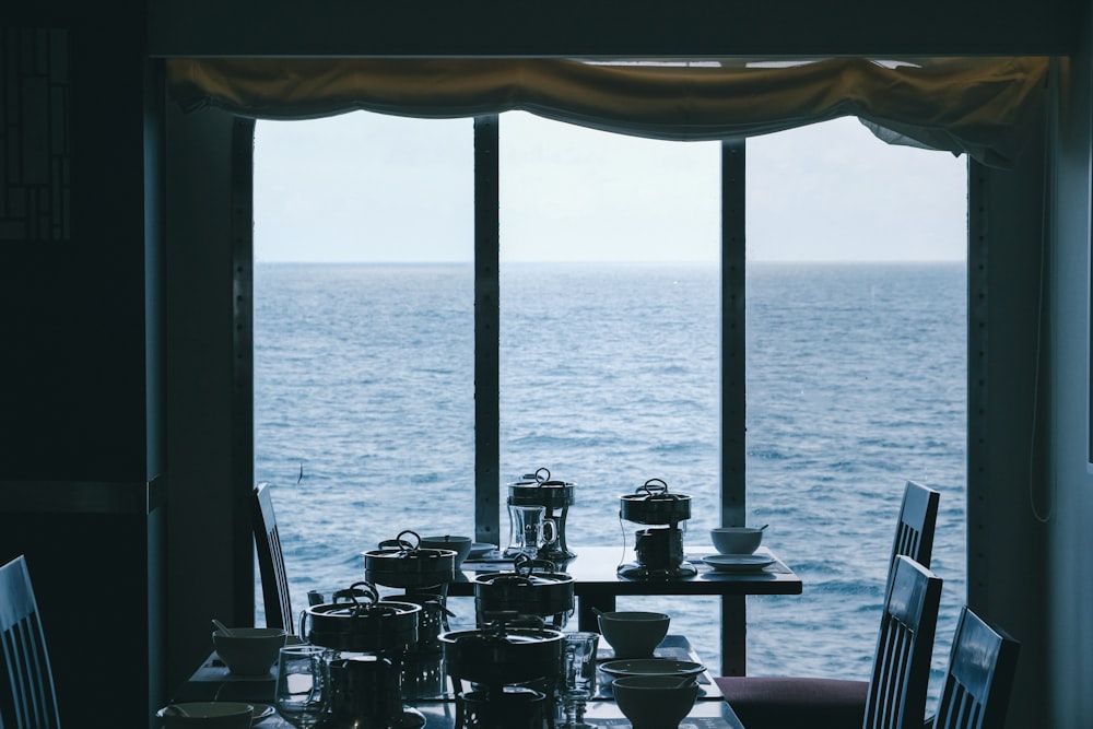 a dining room table with a view of the ocean