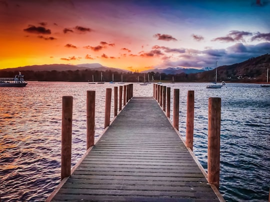 brown wooden dock near body of water during blue hour in Windermere United Kingdom