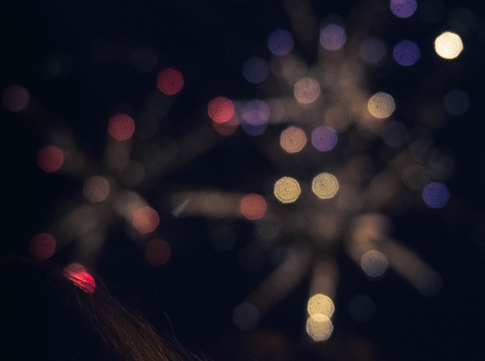 a blurry photo of fireworks in the night sky