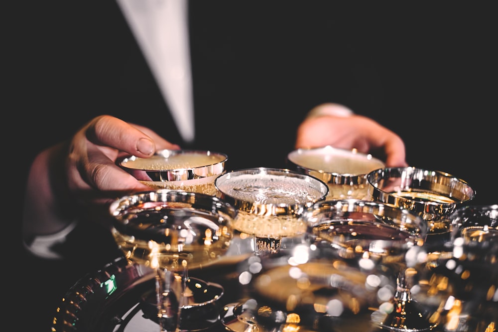 person standing beside martini glasses