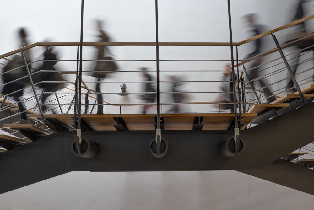 time lapse photography of people passing on bridge